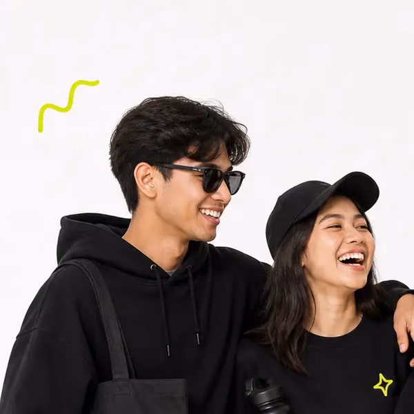 Two friends in a PlayShot hoodie and cap, laughing