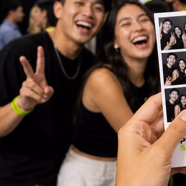 Friends laughing, one holding up a peace sign