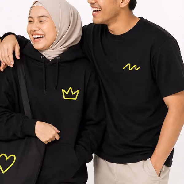 Two friends in PlayShot tees, smiling
