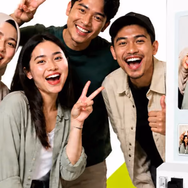 Three friends laughing into the camera