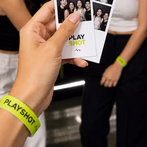 A PlayShot wristband and a fresh photo strip